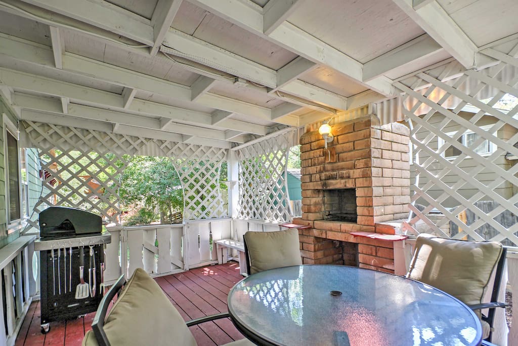 Enjoy a cookout on the expansive back porch with a built-in stone grill and trellis.