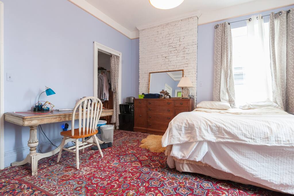 Persian carpet over original wide plank hardwood floors