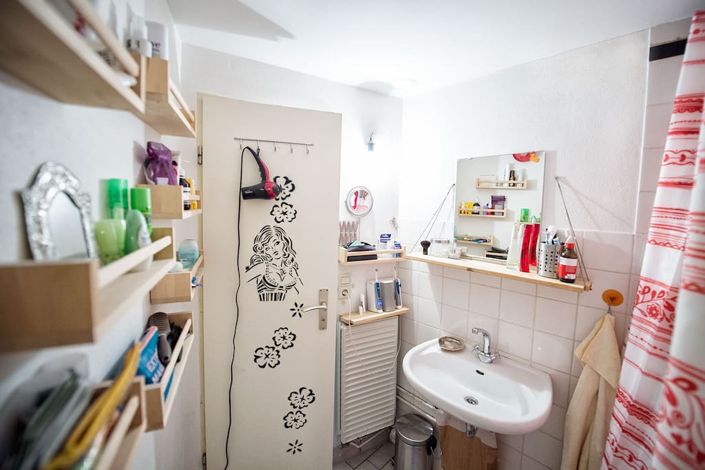 Small bathroom with shower and art work by Lady Aiko.
