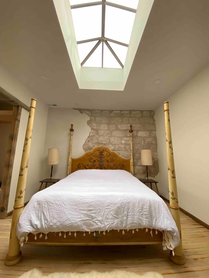 Master suite with a king size bed and skylight