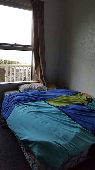 Double bed in room overlooking harbour