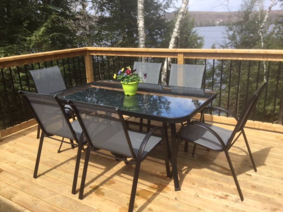 Patio furniture on deck located directly off of cottage
