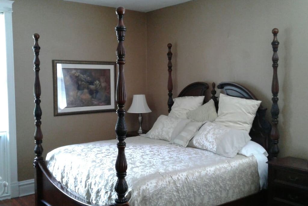 7' tall four poster king bed complimenting 10' ceilings