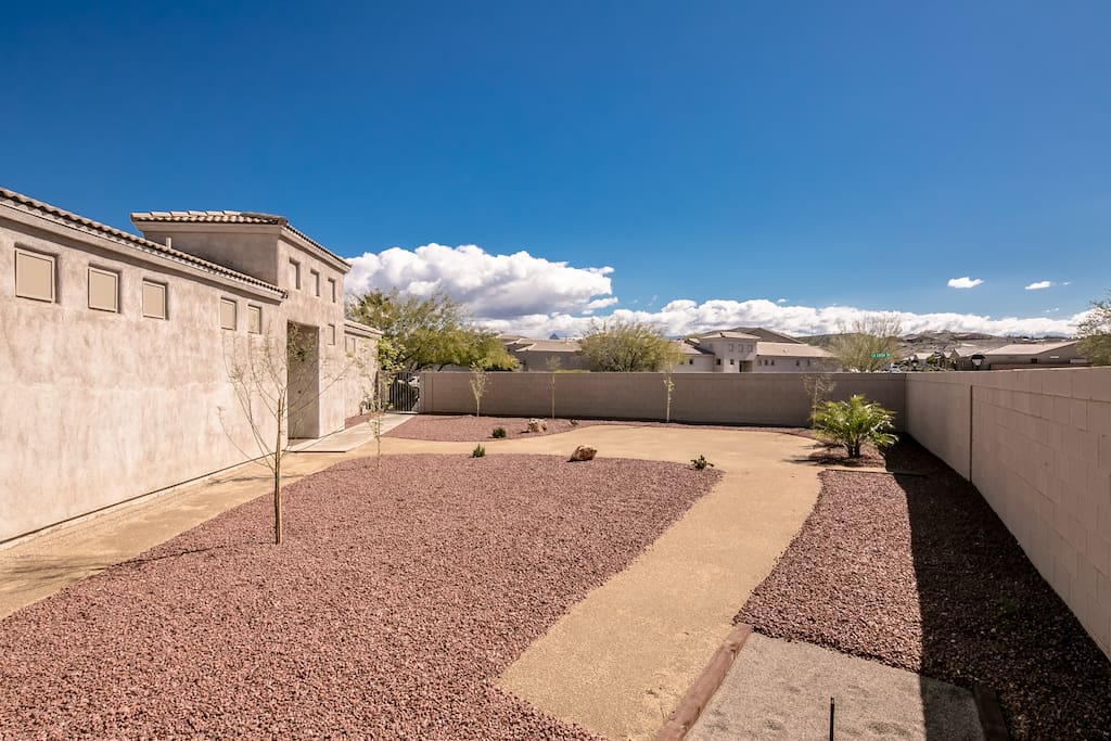 Side/front yard connects with backyard and features the game Horseshoe