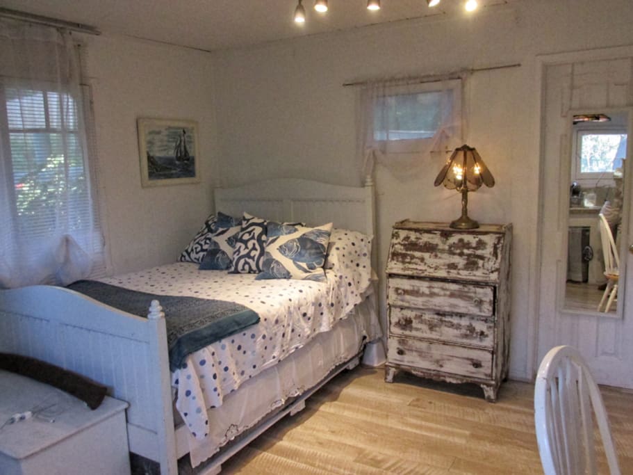 Real size in dimmed lighting. Ultra comfortable full size Tempurvedic mattress with oceanic pillows, vintage plank flooring.