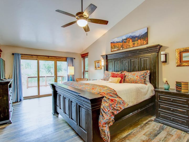 Master bedroom with attached full bathroom and king sized bed.  Walk out to the hot tub.  TV 