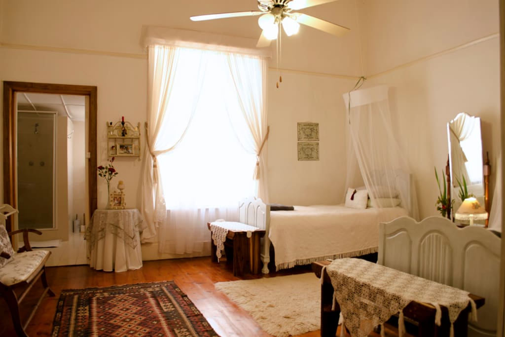 Cheerful room with 2 single beds and a private bathroom with a shower.