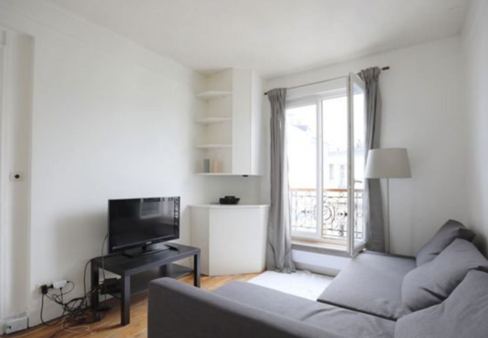The living room has a sofa that turns into a double bed for 2 and in the white corner cabinet is hidden the washing machine and nobody can notice it !