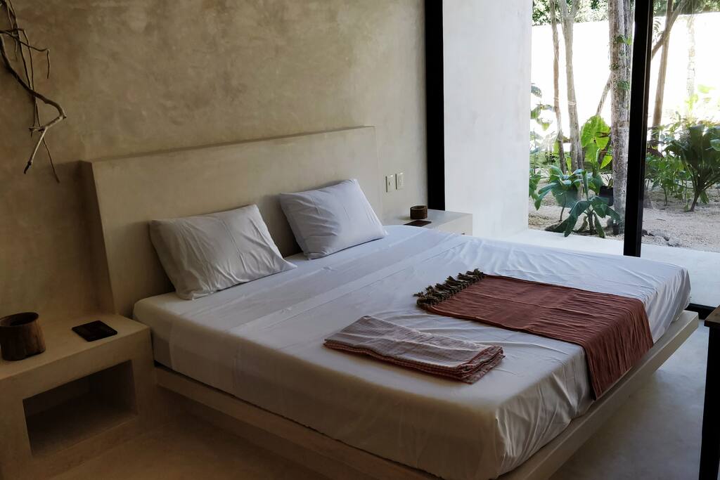 Room B: King size bed with access to garden and pool.