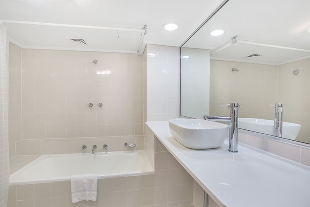 Large Modern bathroom with full sized bath and shower over the bathtub