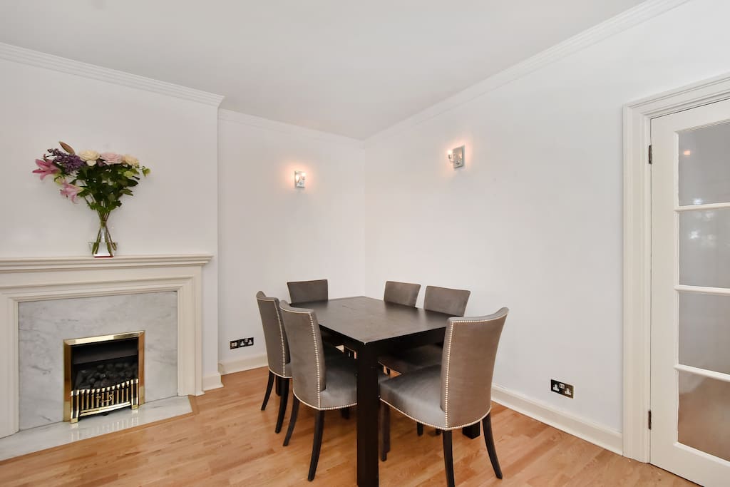 The dining table for 6 and the feature fireplace in the living room