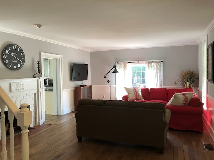 Living Room with Sectional and Hide a Bed sofa plus 55” Smart TV w/ DVD player plus long dining room table!