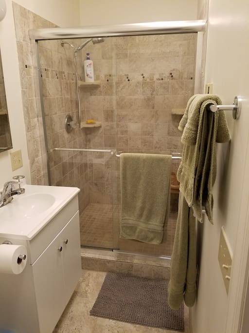 roomy tile shower with heated floor