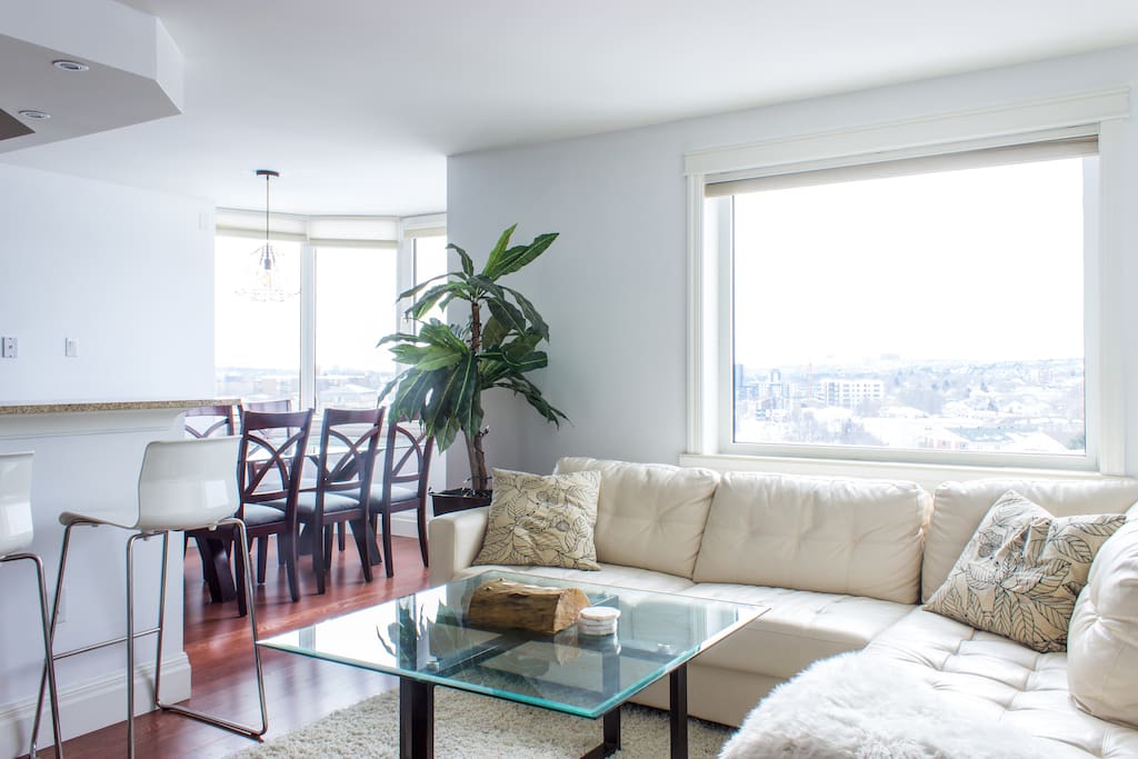 Modern living space looking to the bright open dining area.