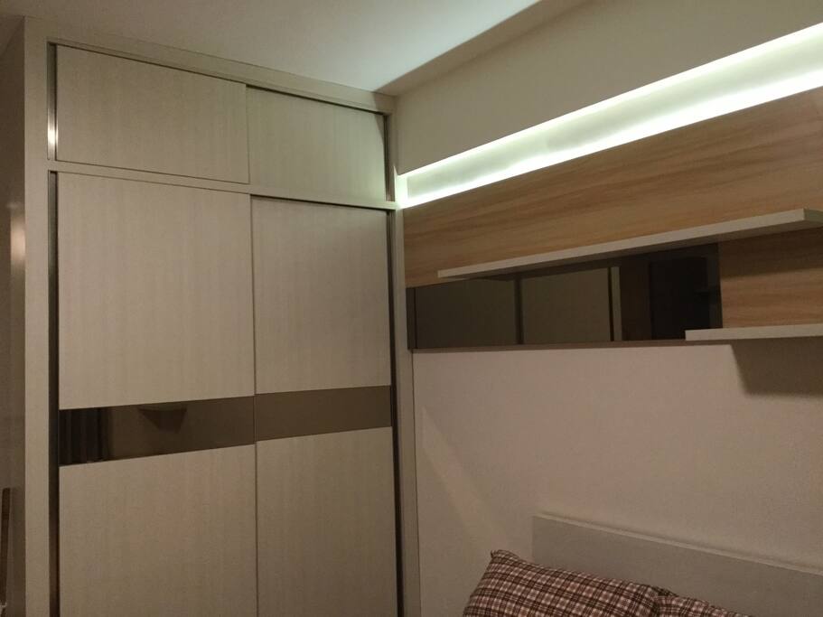 Wardrobe with hangers inside, you can put your suits, dresses, or your casual clothes inside