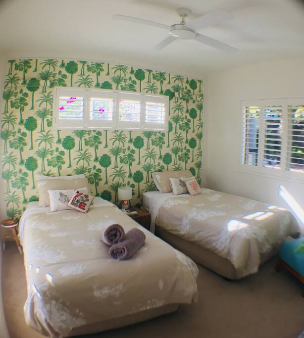 Bedroom 2 features comfy twin beds that can easily be pushed together, plus linen and stylish wallpaper!