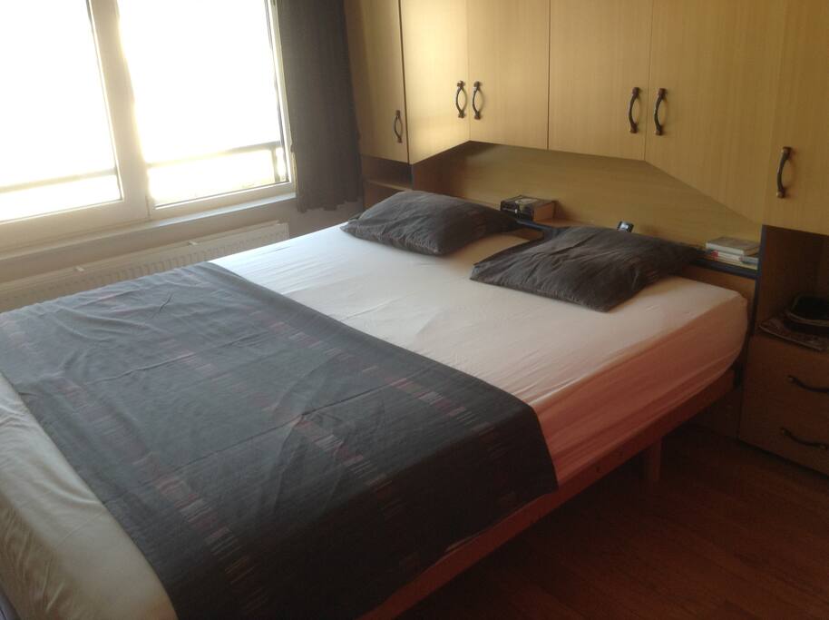 Bedroom with a two-person bed and wardrobe to hang/place clothes