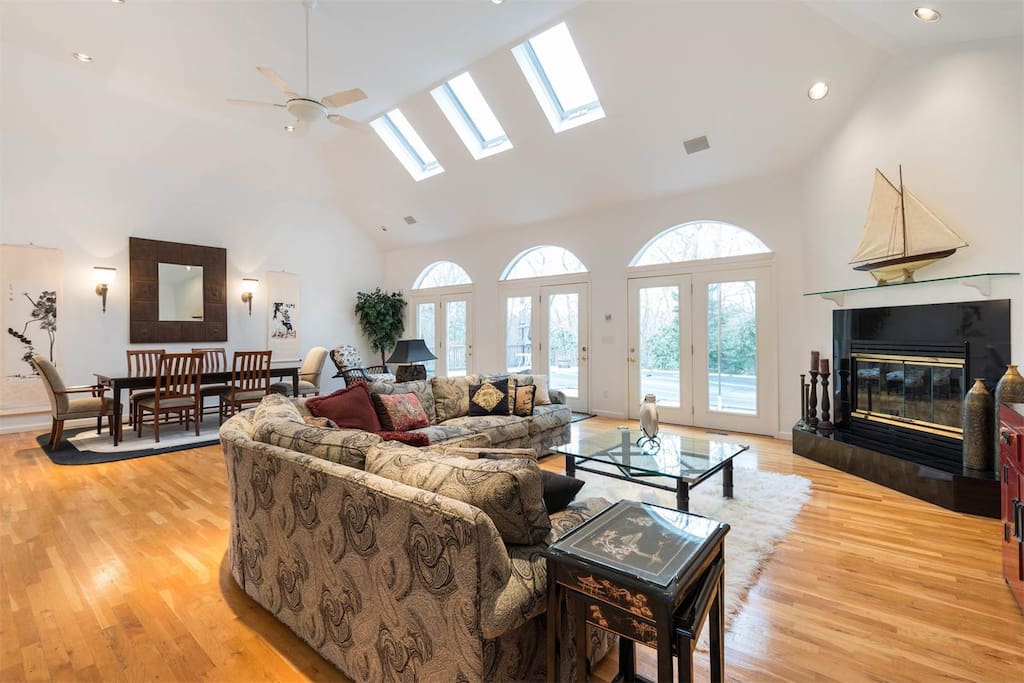 Great Room with double height living area / dining area / Cozy Up by the Fireplace.