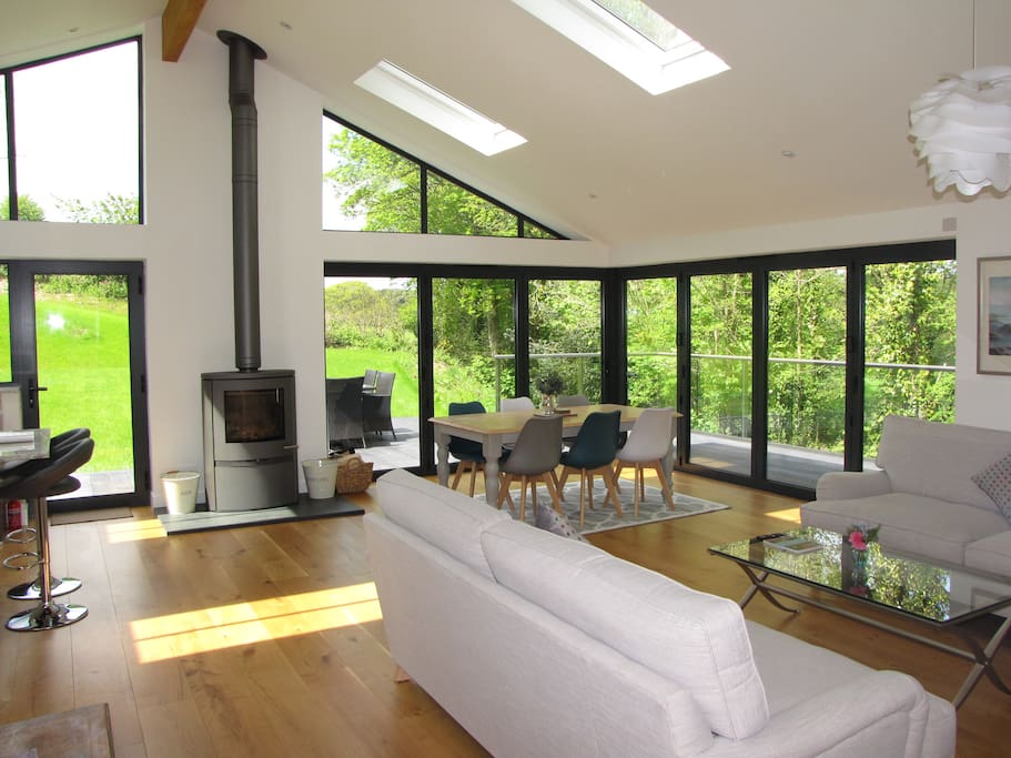 Sitting room with Bi Folds opening onto deck and garden. Wood burner for cosy winter nights.