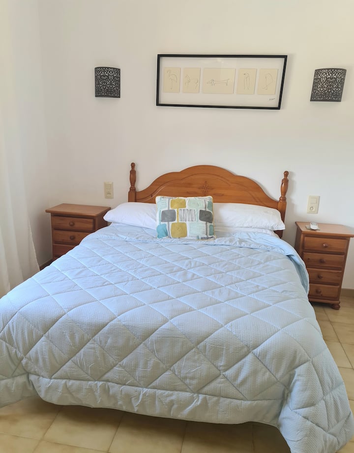 Double bedroom with views over the pool and garden. Fitted wardrobes, air con and celing fan. Bed size 150cm x 200cm.