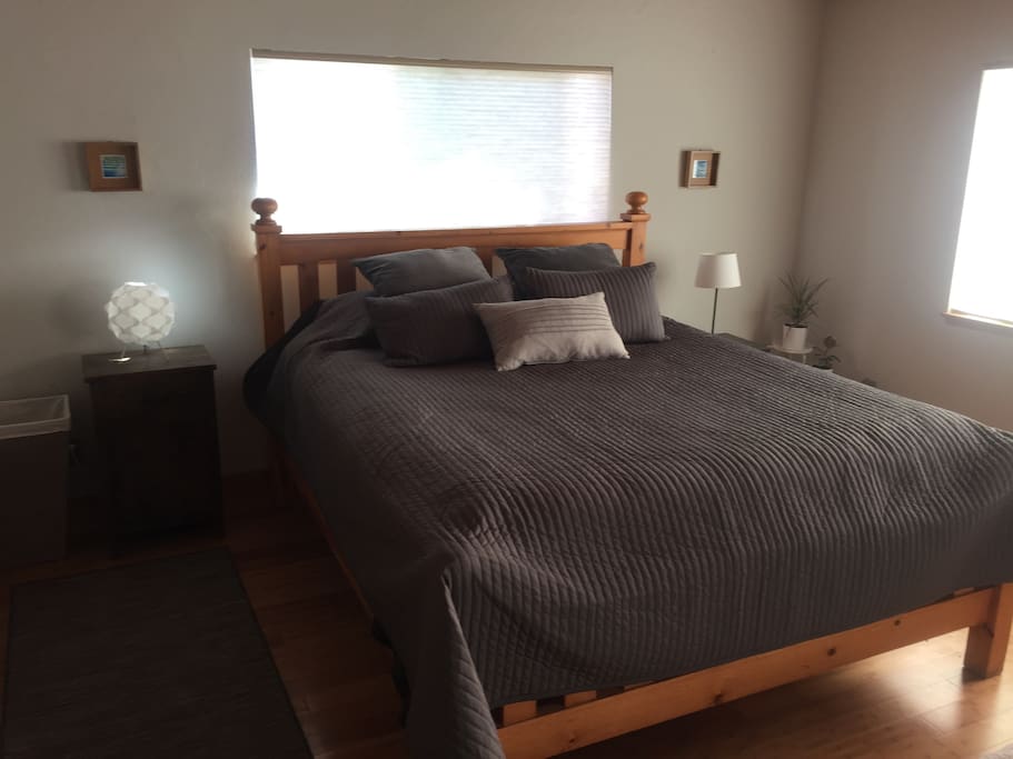 Cal King Bed in the light filled master bedroom with huge closet. Local surf, and ocean themed artwork adorn the walls.