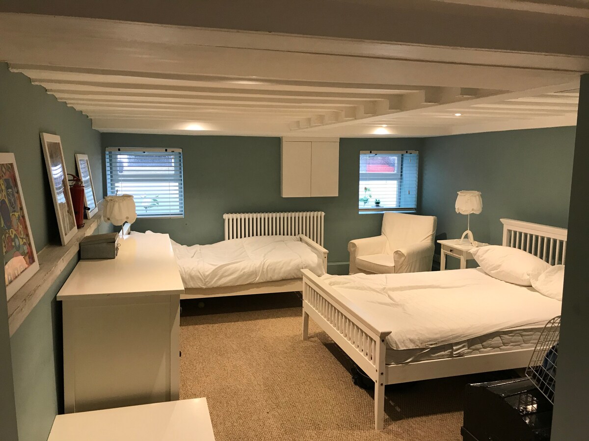 The lower ground floor bedroom sleeps three with a double bed and a single bed