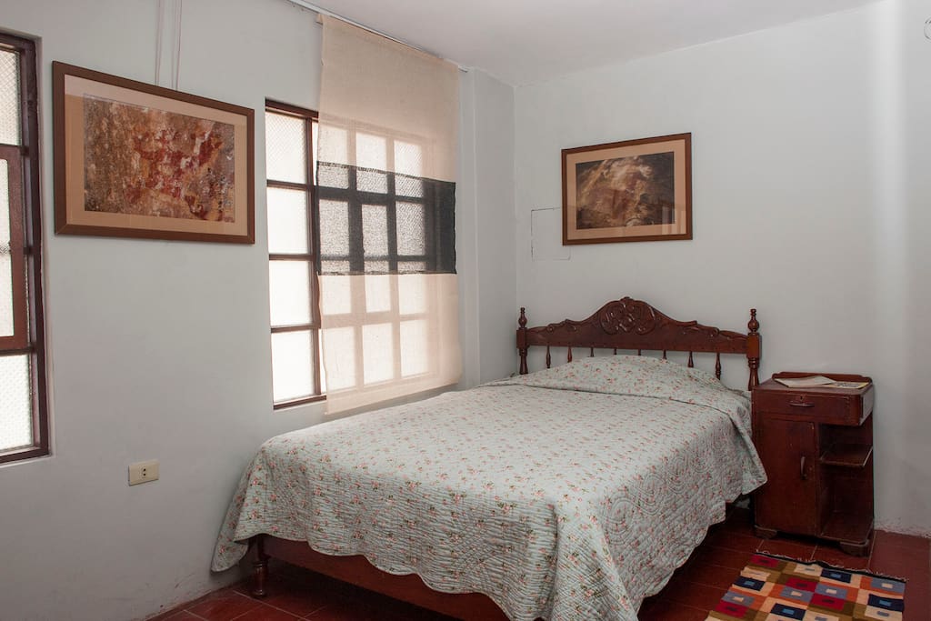 A cozy bed in a well lit room
