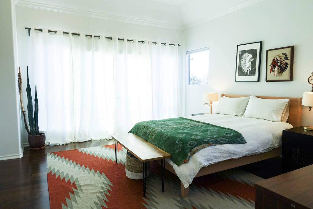 Master with small balcony behind curtains