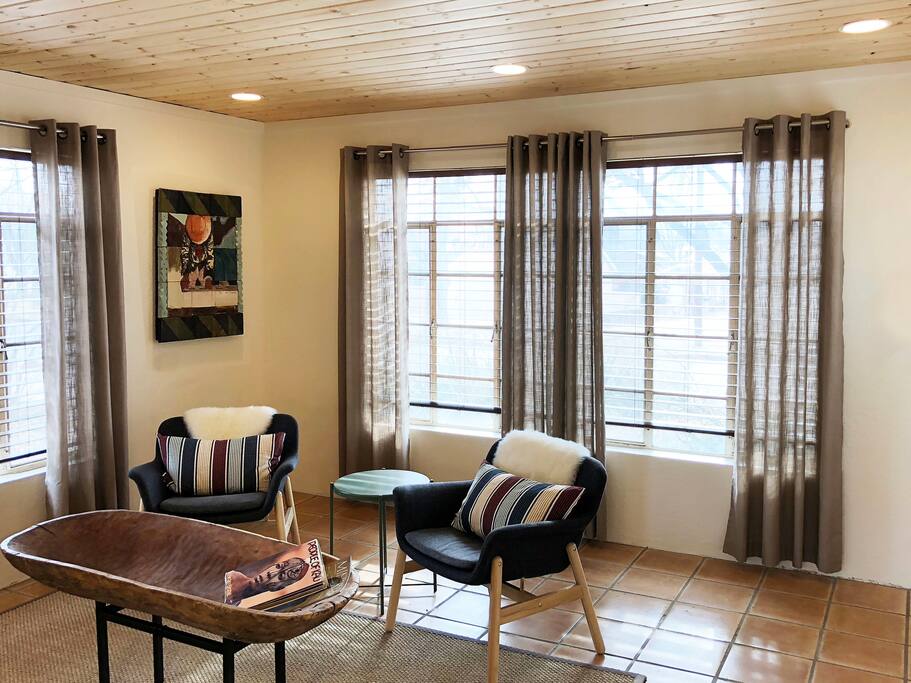 The living room is bright and airy, but the blinds and curtains can be closed for privacy and for days you might want to sleep in.