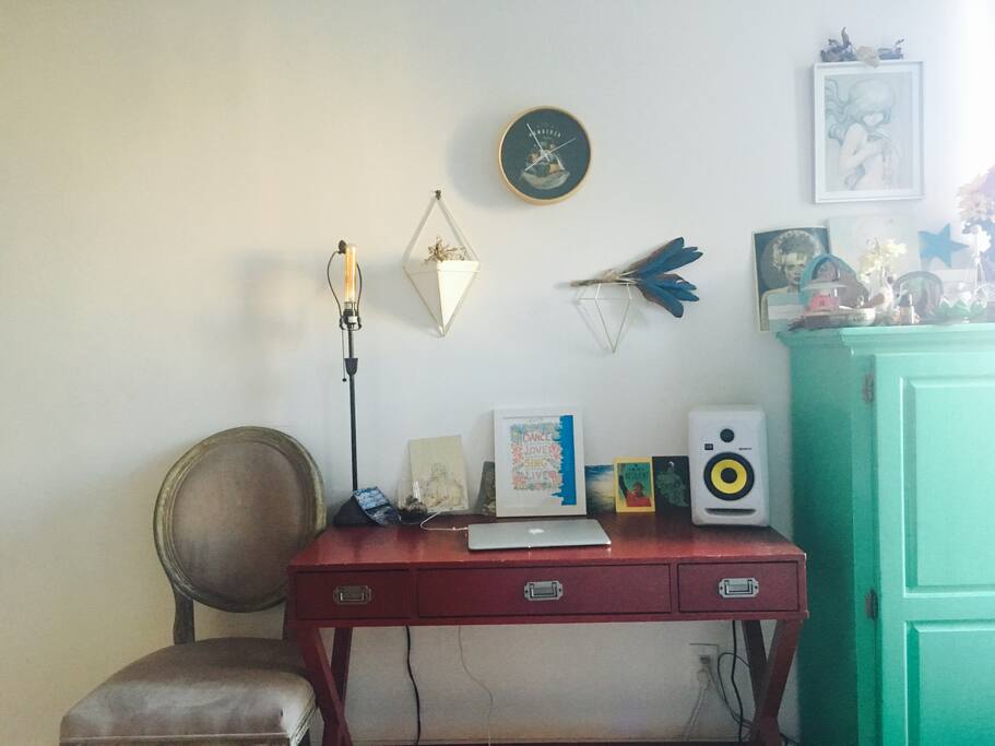Desk equipped with studio monitor sound system.