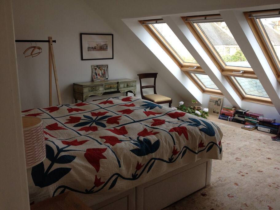 Kingsize bed in light airy room with views across garden to the Peatland Hills