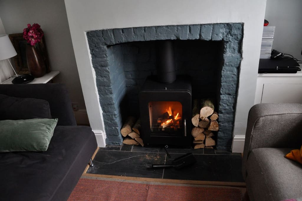 The front room/lounge with TV, comfy sofas and a wood stove