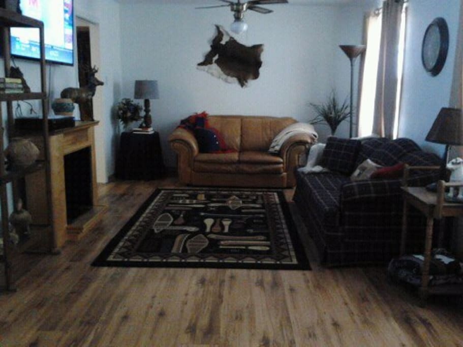 Living Room has 50" TV 2 Sleeper sofas, fireplace, setting for 9