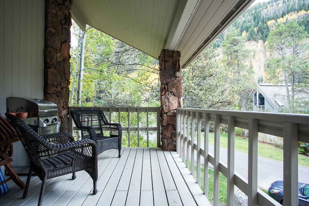 Balcony off master bedroom and living area with gas grill and seating for 2.