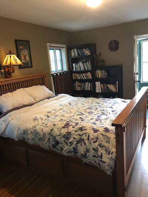 Master bedroom - with great art and books, stained glass windows, and its own porch!