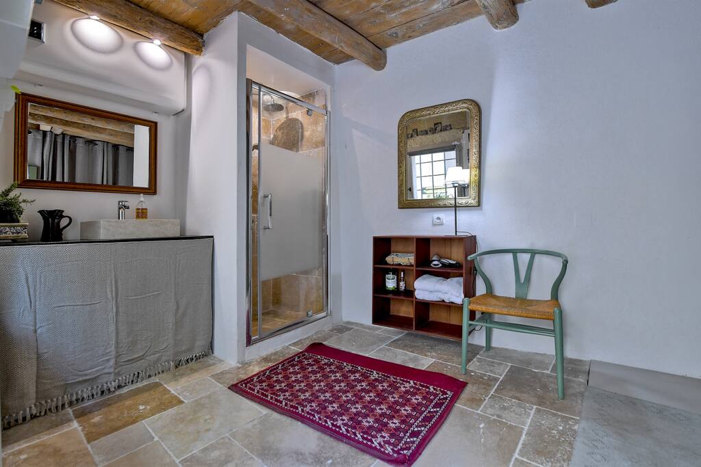 Built-in shower and wash basin in wet room with washing machine on the ground floor.