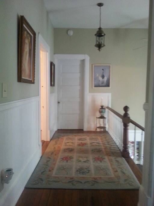 This is the hallway upstairs. Your bedroom is the door on the left...visible when you come up the stairs.
