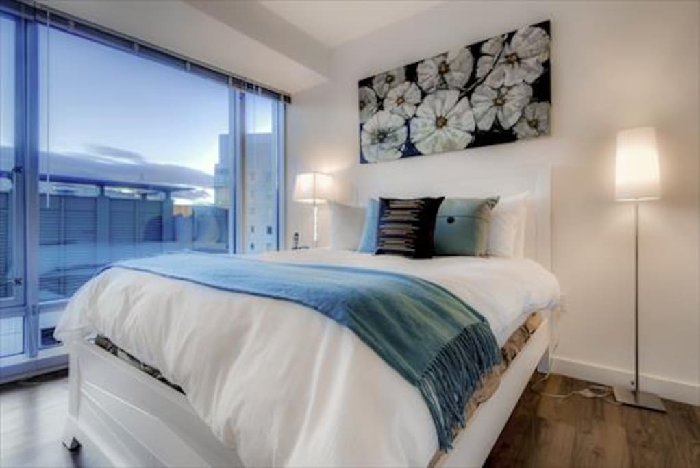 Comfortable bedroom with a queen bed, spacious closet and tons of natural light.