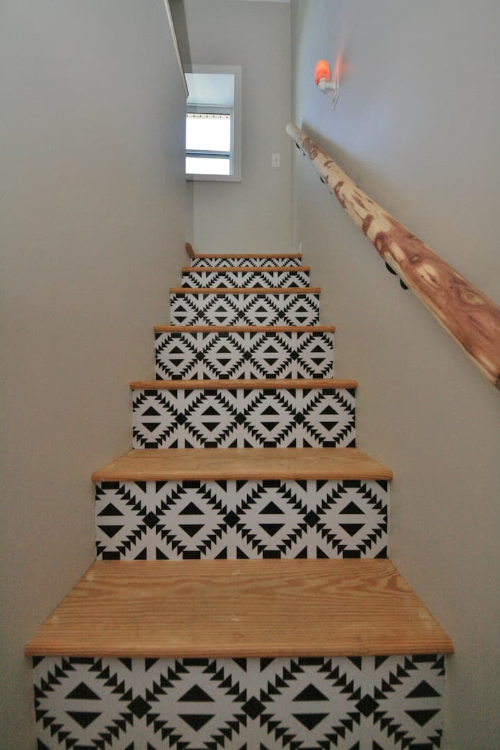 Our property has an abundance of cedar trees and this stair railing was hand carved on site