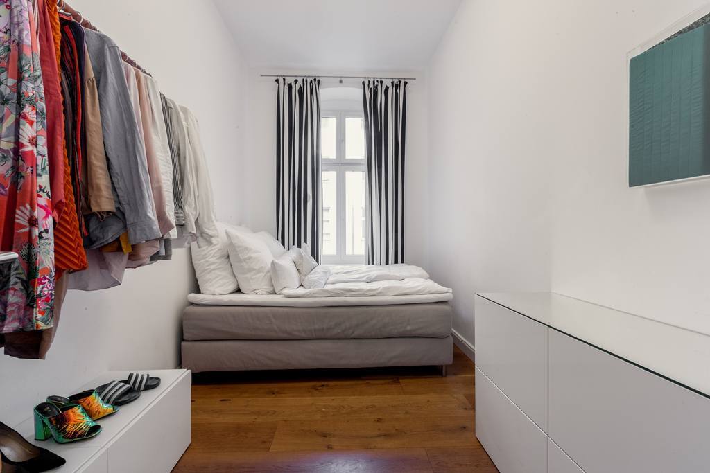 Cozy bedroom with box spring bed and window to the quiet backyard