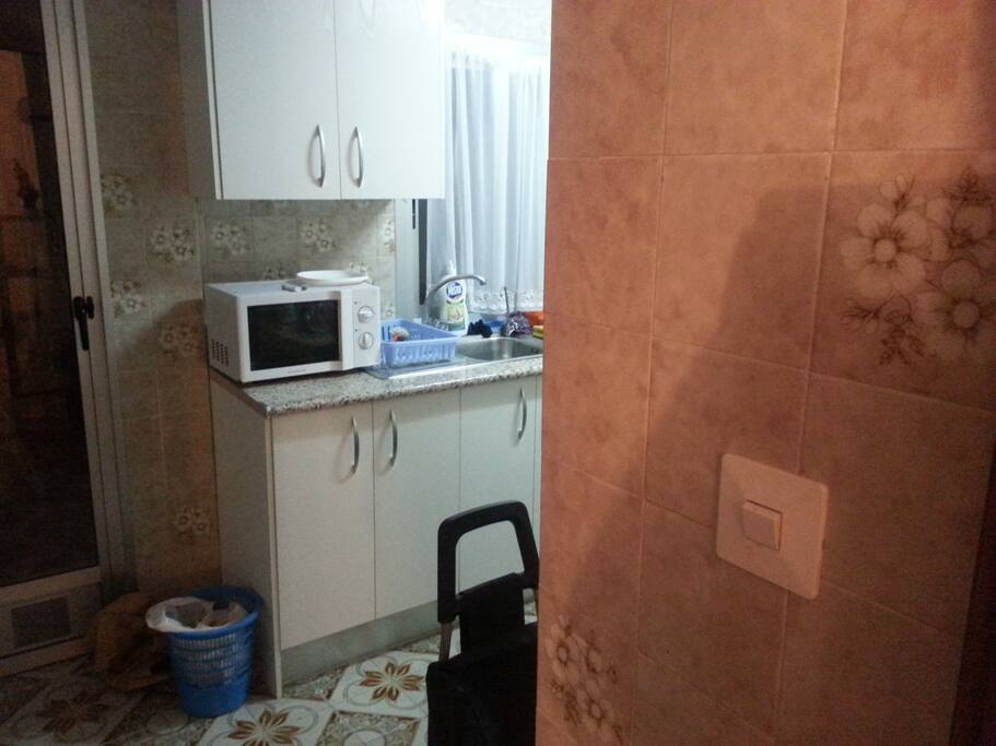 Kitchen Area leading to the small balcony and then bathroom