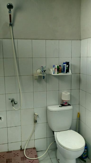 bathroom with shower and closet