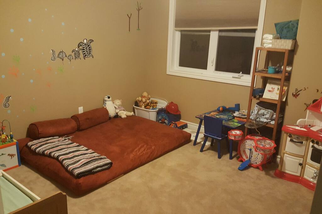 kids room with one futon mattress, one toddler bed (or crib) and toys. Closet space available.