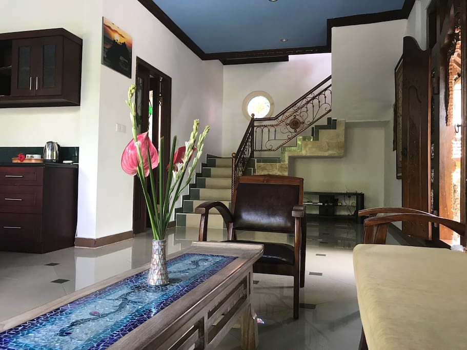 Entryway, living room and edge of kitchen.
