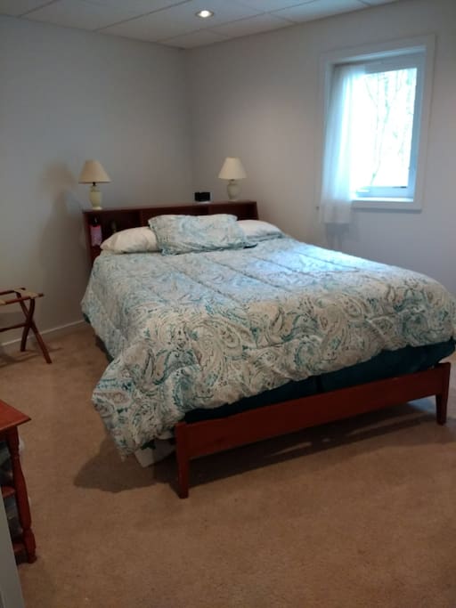 Enjoy this queen-size bed in your private bedroom.
