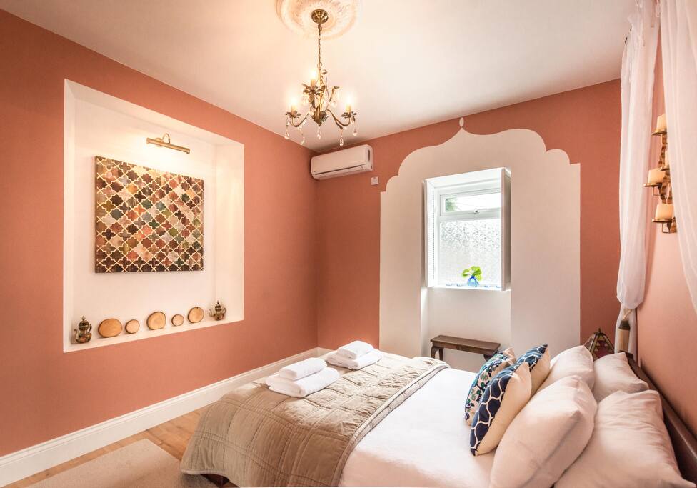 Bedroom with a king size bed and a large built in wardrobe.