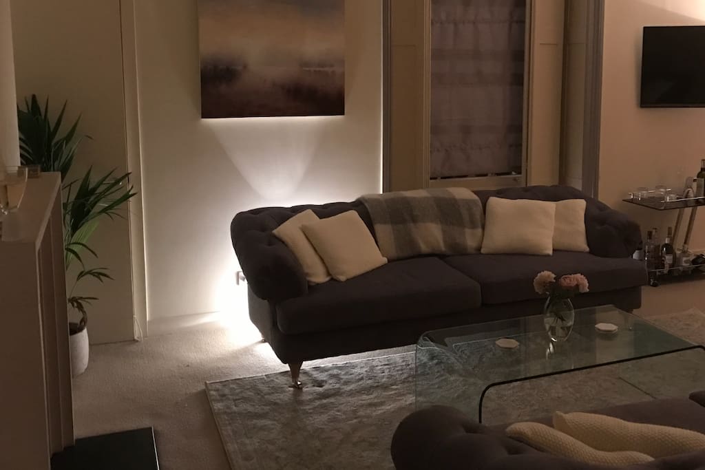 Luxurious living room with large sofas and original artworks