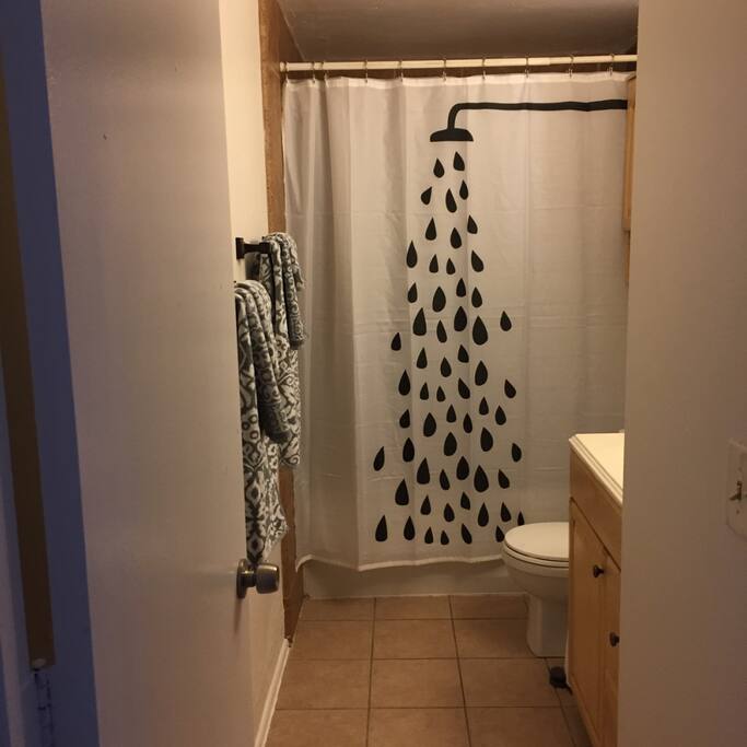 Shower/tub with shampoo, conditioner, and bath wash gels.