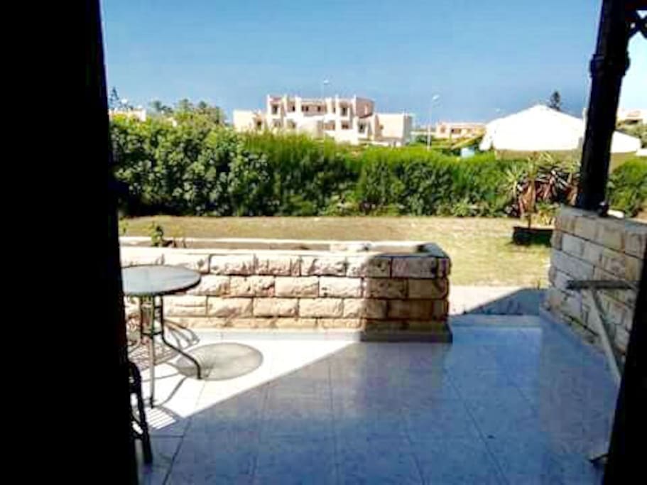 The terrace, the view from the living room showing the front garden and passage to Marina Lake
