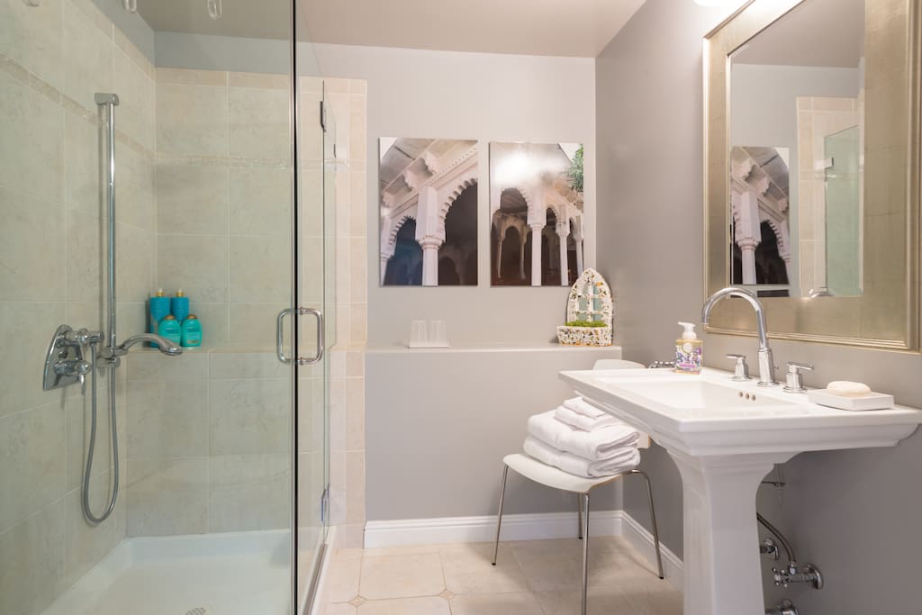 Bathroom with all amenities - including hair drier, plush robes, shampoo, body lotion, and every day essentials